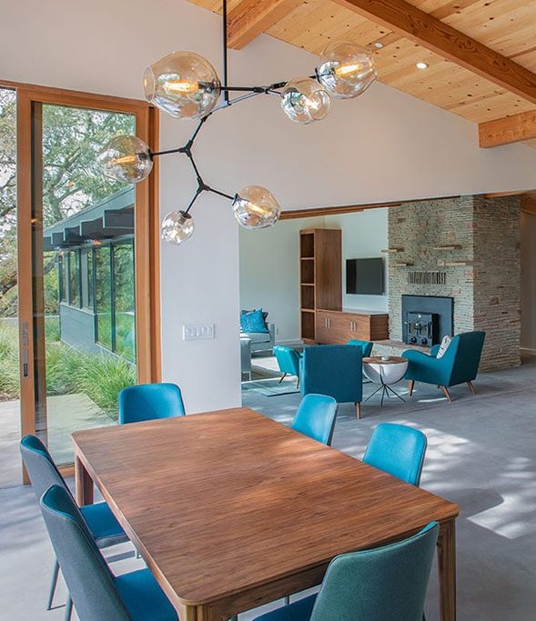 seating areas in home accented with blue chairs