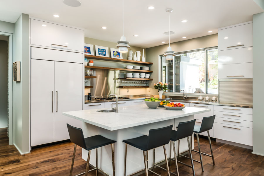 Kitchen with white cabinetry and a large island that has a white granite countertop
