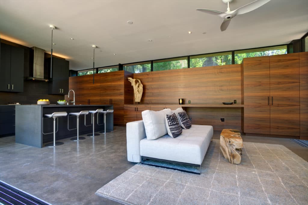 wide view of a modern living area and kitchen of a custom build home.