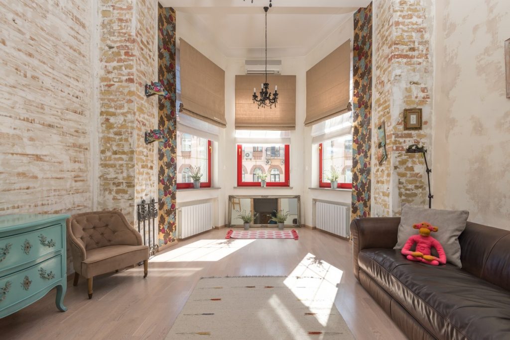 interior of a modern home with light bright walls and tall windows