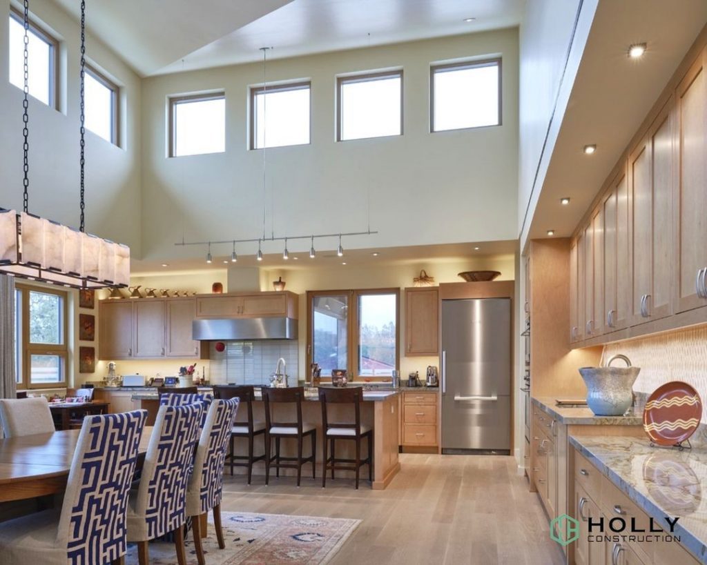 kitchen and dining room space in a home with tall ceilings