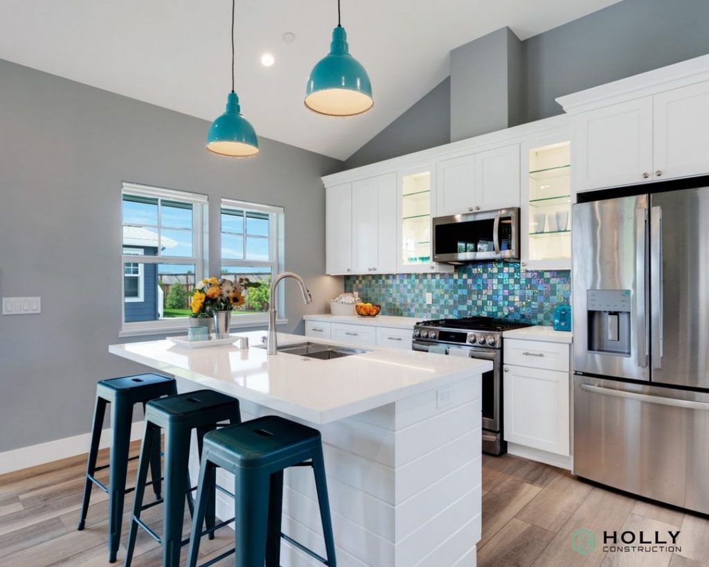 kitchen in a home with white counters and blue walls