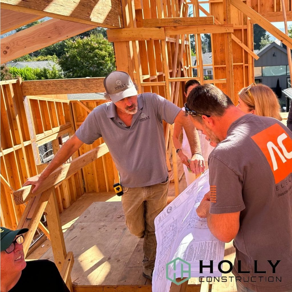 Wooden frame of housing with team talking in a group