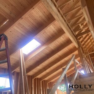 wooden house structure with bright light coming through skylight.