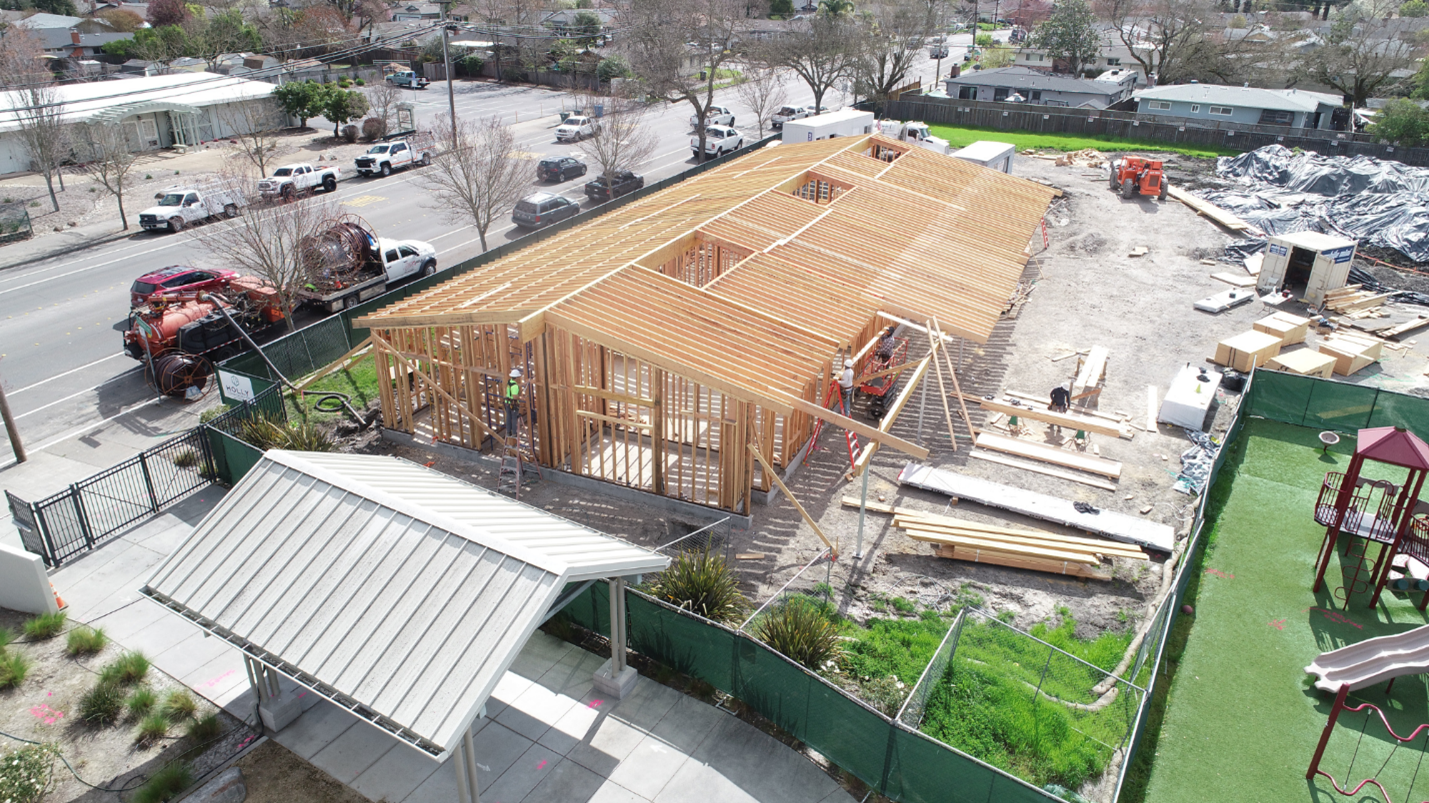 A bird’s-eye-view of the framing of a building being constructed.