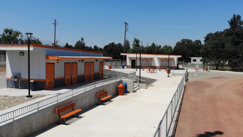 A high school field stadium facilities newly constructed and accented in orange.