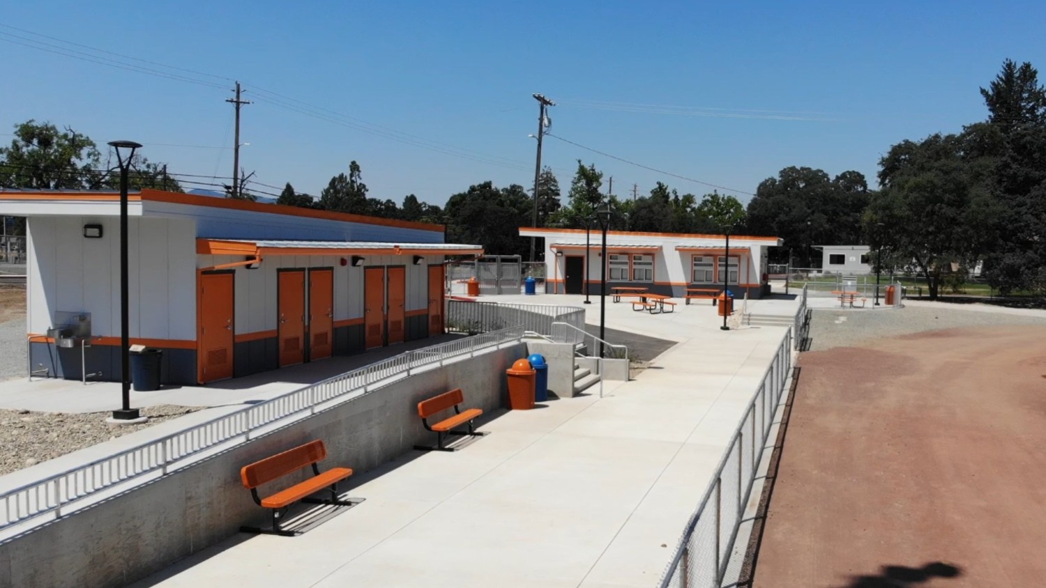 A high school field stadium facilities newly constructed and accented in orange.