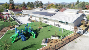 A newly constructed elementary school next to a children's playground.